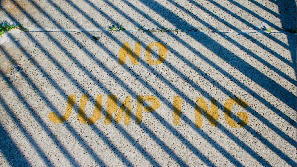 Clermont Florida Beloved Church image of dock with crossing shadows over a no jumping sign.