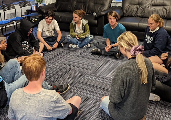students sitting in a circle on the floor